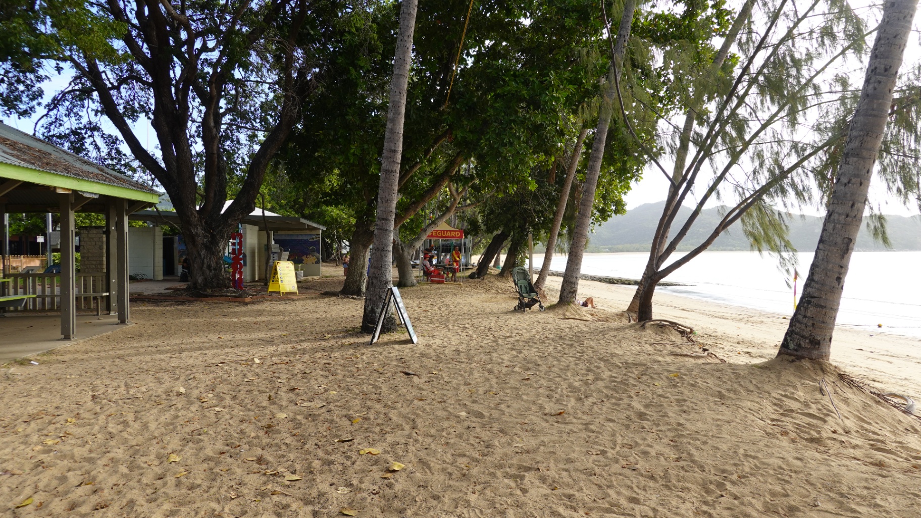 Nelly Bay foreshore with palm-lined beach and waterfront cafes, Magnetic Island