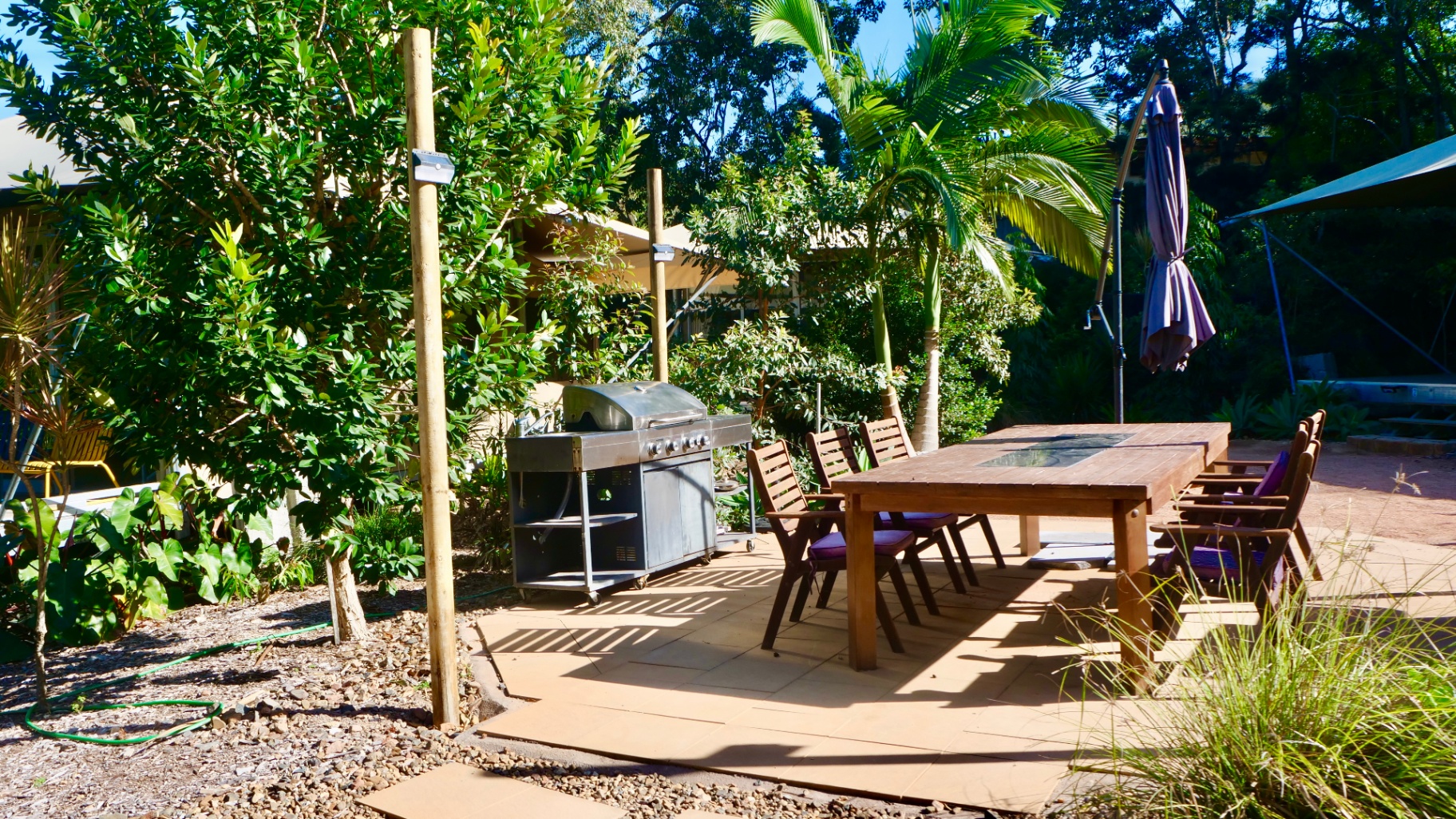Outdoor dining and BBQ area in the tropical gardens, Magnetic Glamping